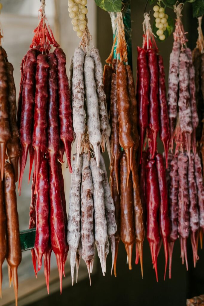 From below of various georgian national homemade delicacy churchkhela made of grape juice walnuts and honey hanging in market stall