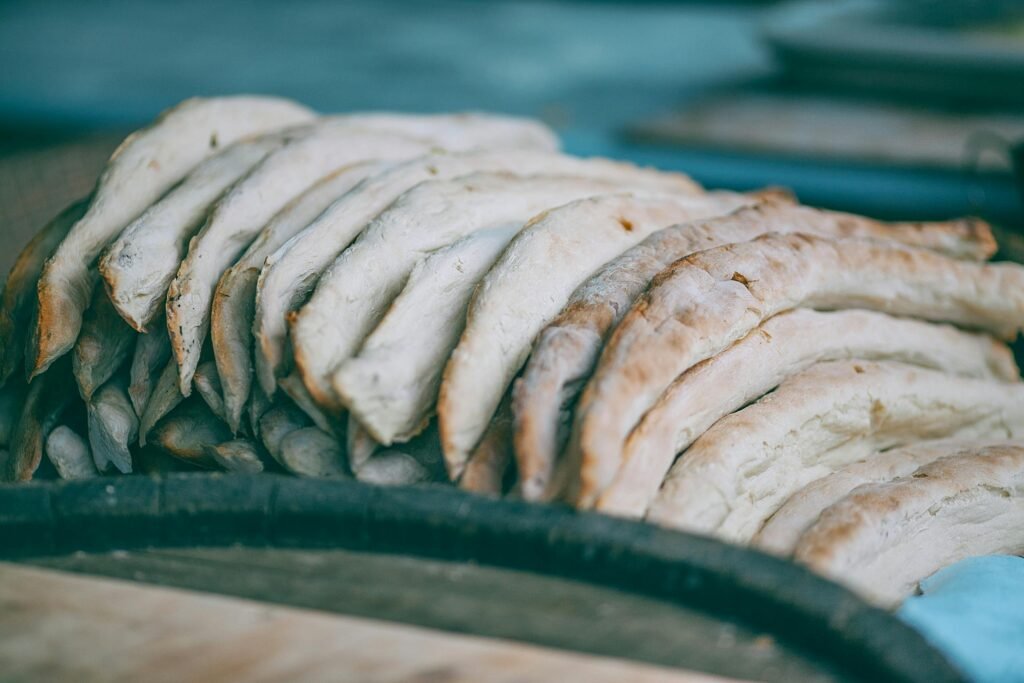 High angle of fresh delicious baked traditional Georgian shoti bread in heap in bakery